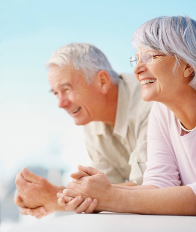 Older couple looking over the side of a condo rental's balcony